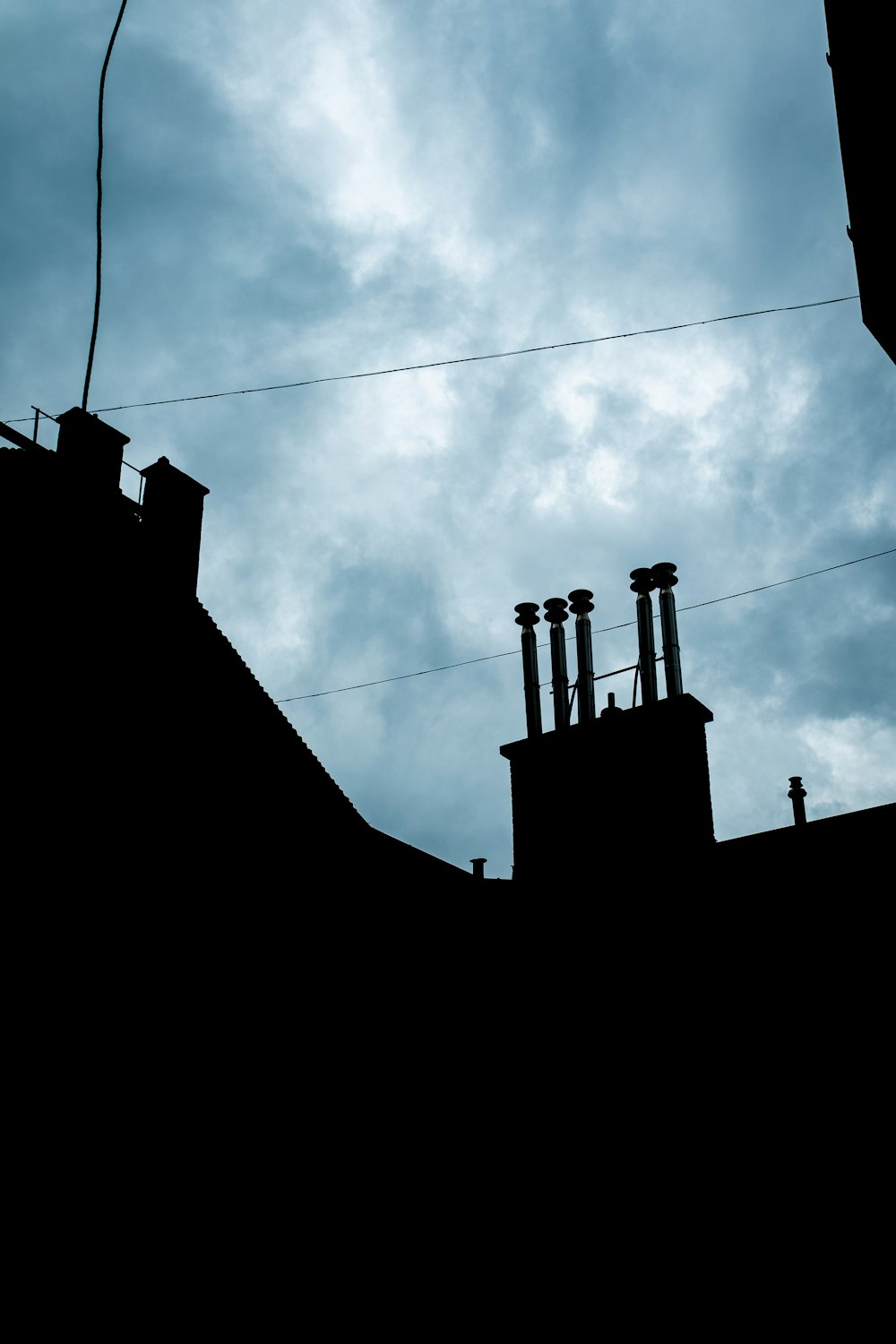 the silhouette of a building against a cloudy sky