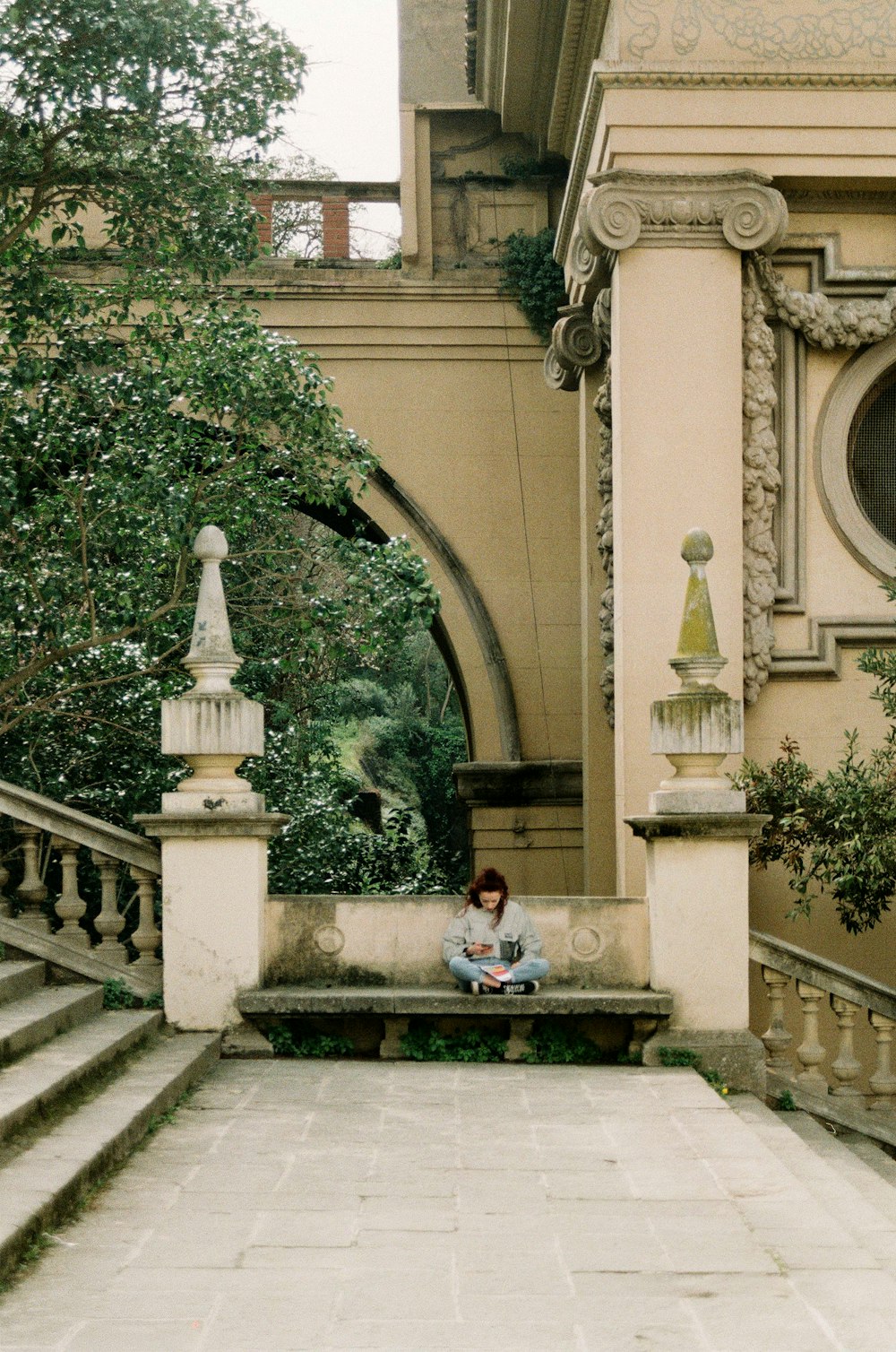 a person sitting on the steps of a building