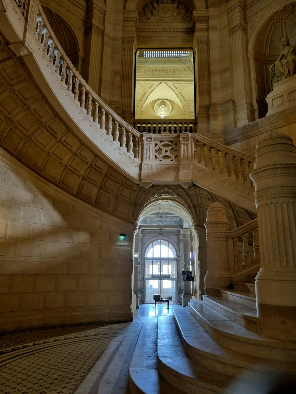 a staircase in a building with a clock on the wall