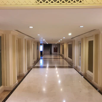 Bright and clean apartment building hallway with polished stairs and sparkling surfaces.