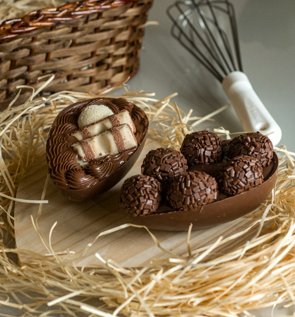 a basket of straw with some chocolates in it