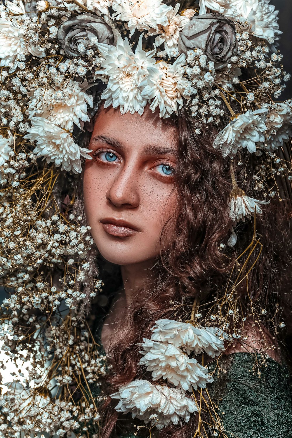 a close up of a woman with flowers in her hair