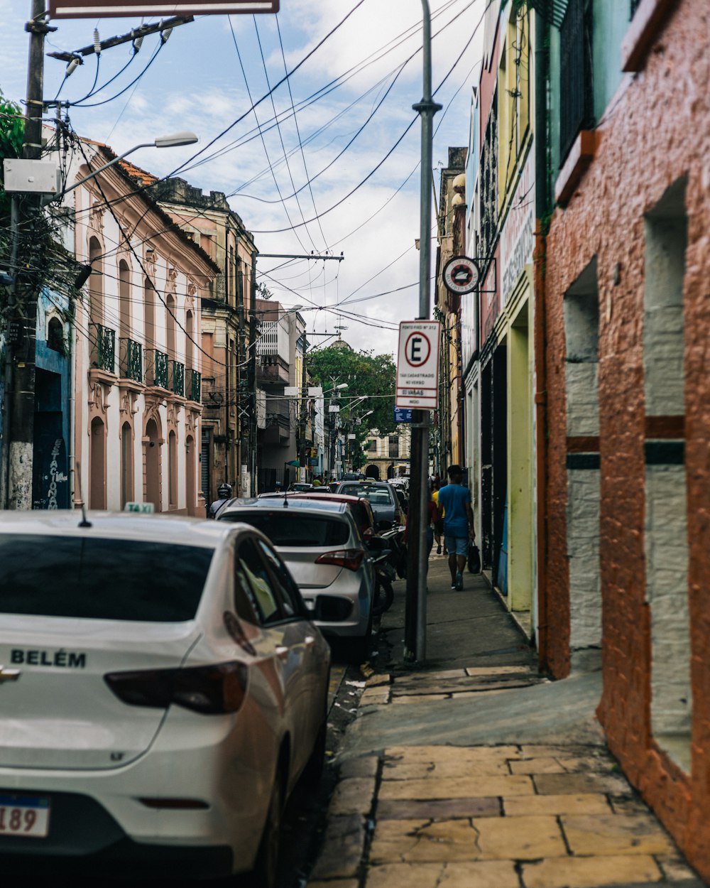 cars parked on the side of a street next to buildings