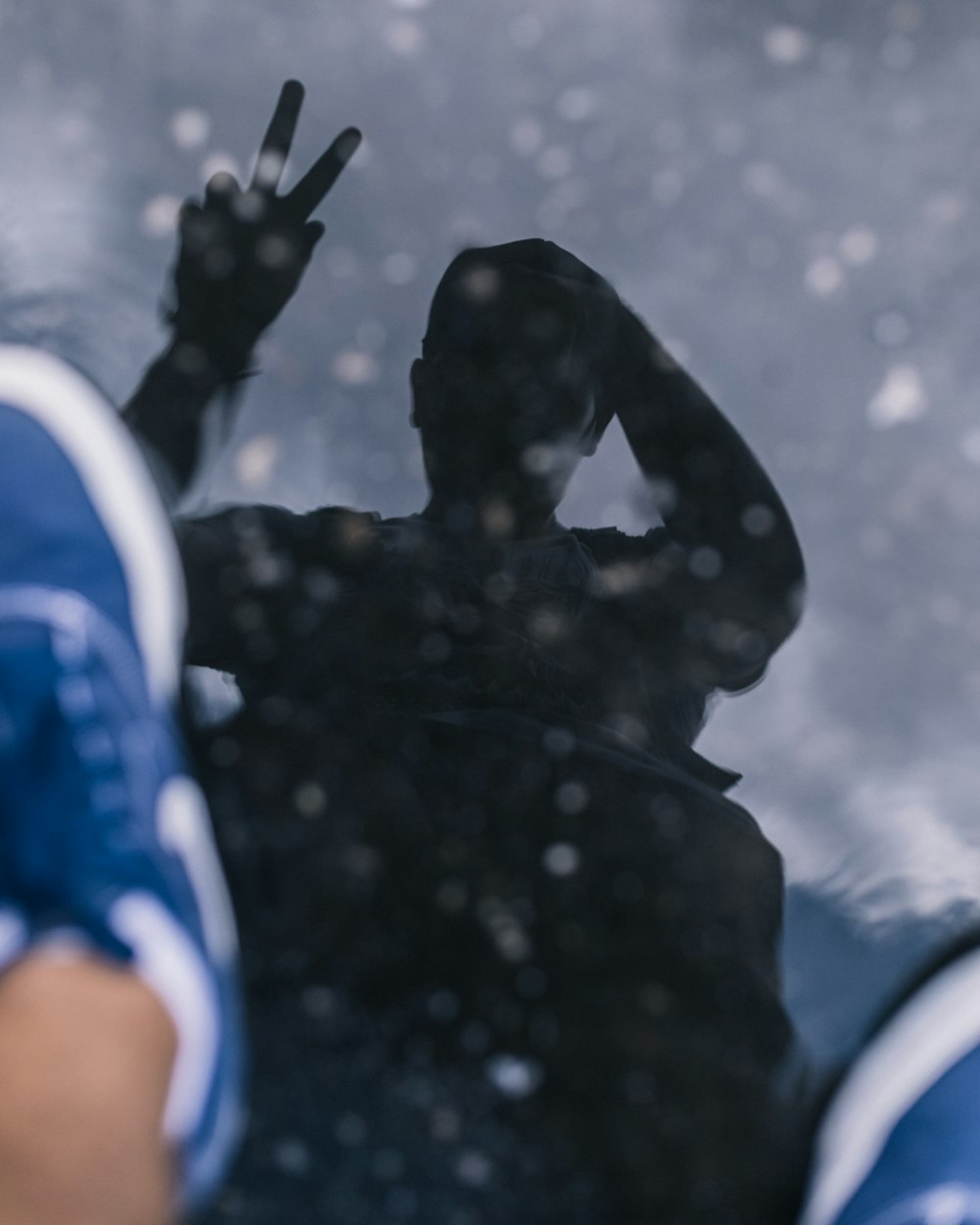 a reflection of a person holding a peace sign