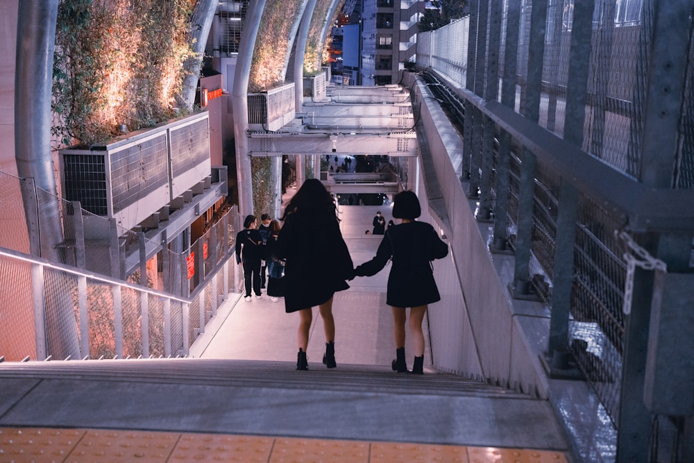 a person walking down a sidewalk in front of a building