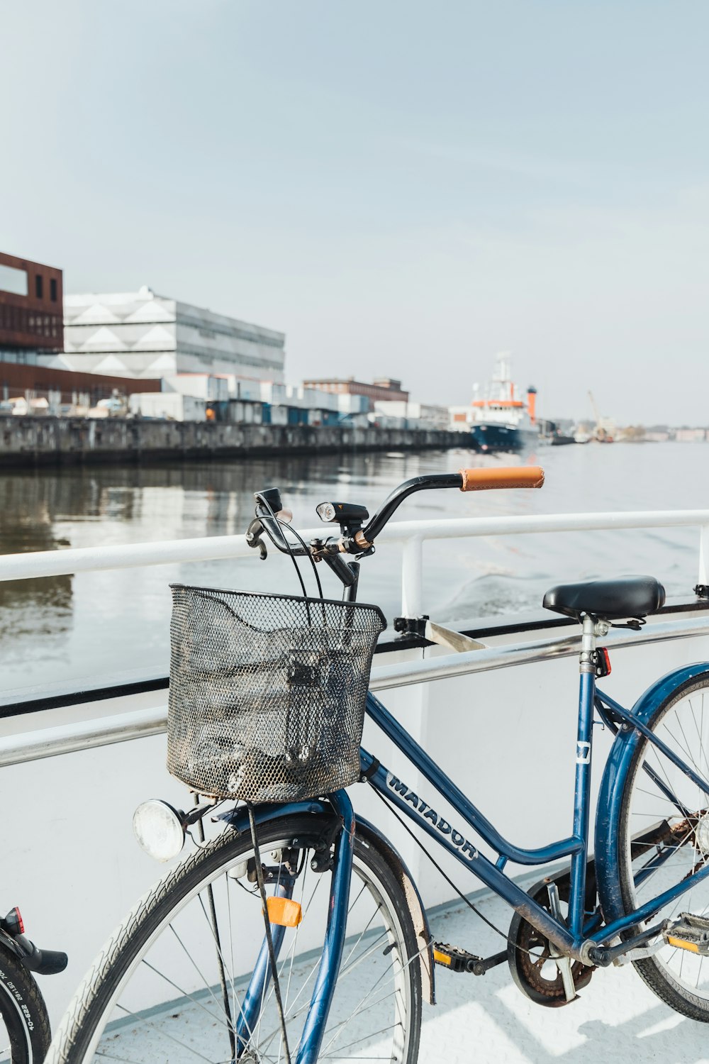 a blue bicycle parked on the side of a boat