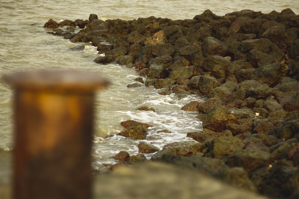 a rock wall next to a body of water