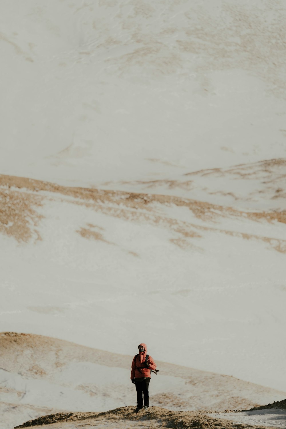 a man standing on top of a sandy beach