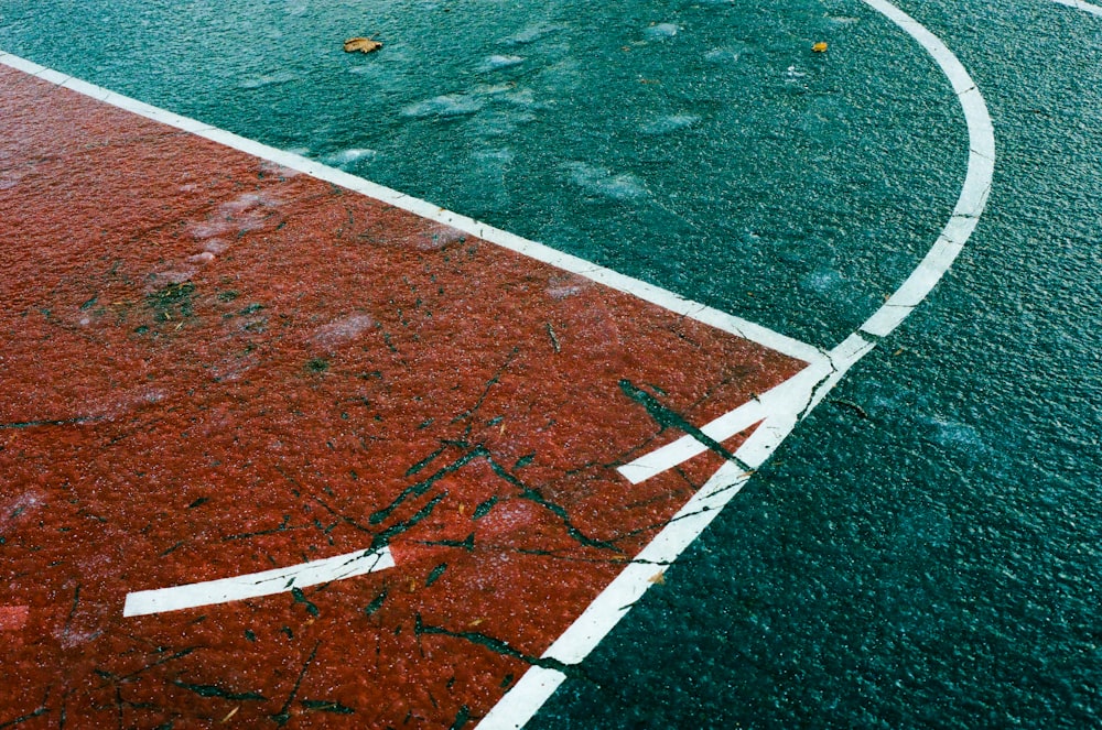 a tennis court with a red and white line painted on it