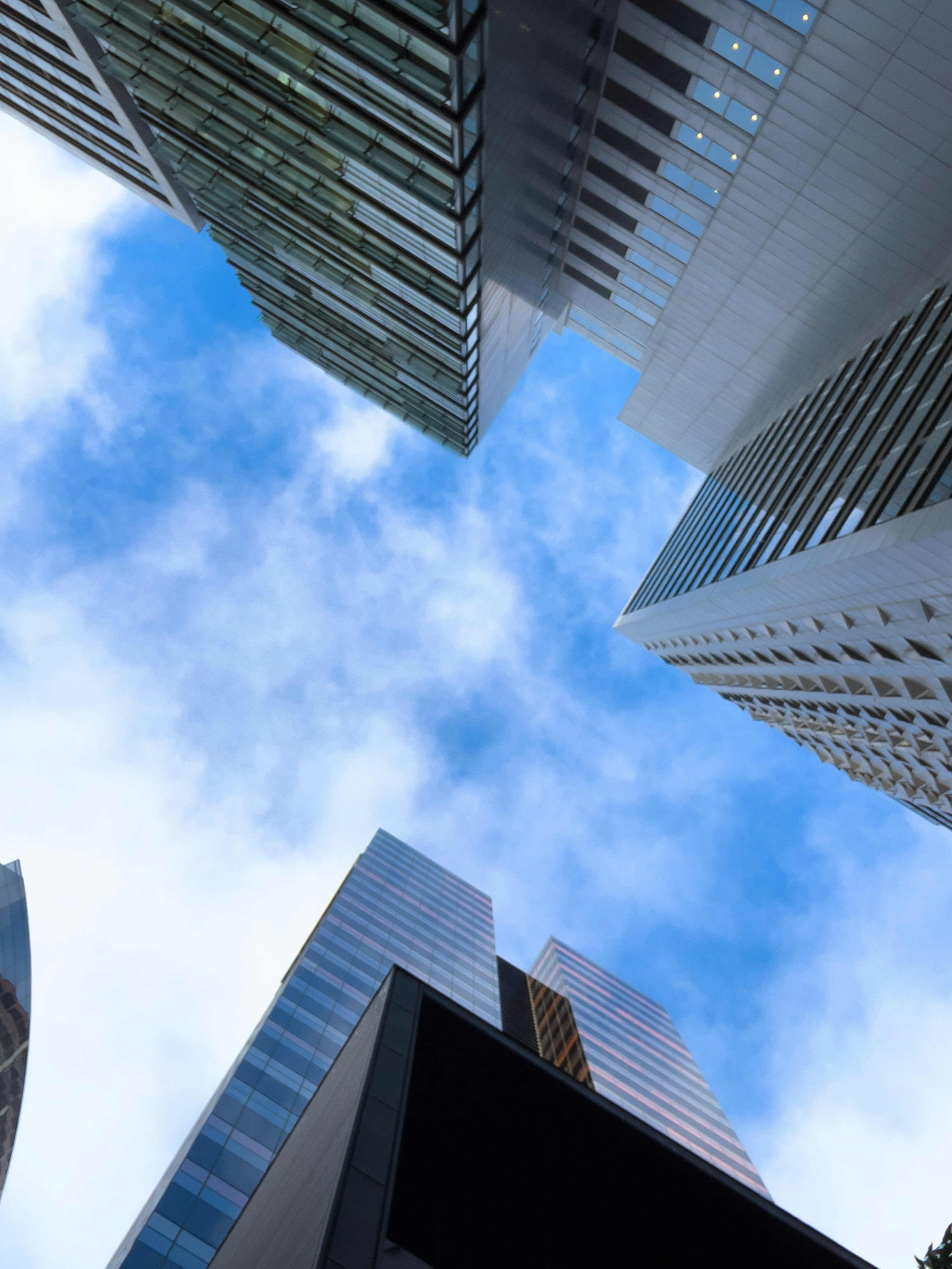 a group of tall buildings with a blue sky in the background