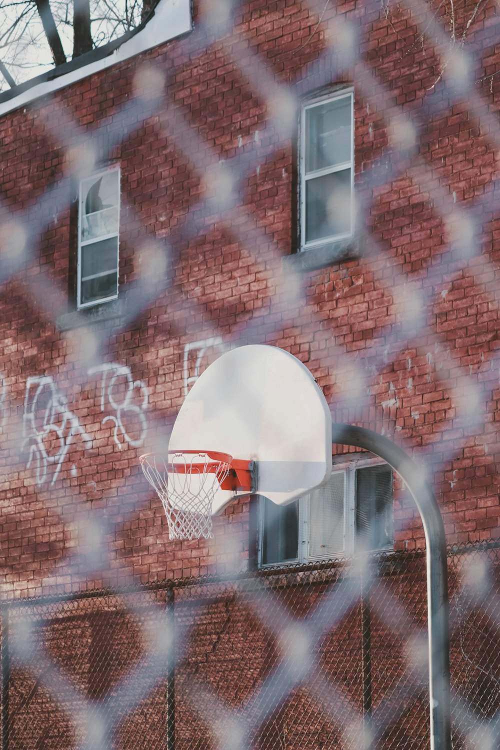 a basketball hoop in front of a brick building