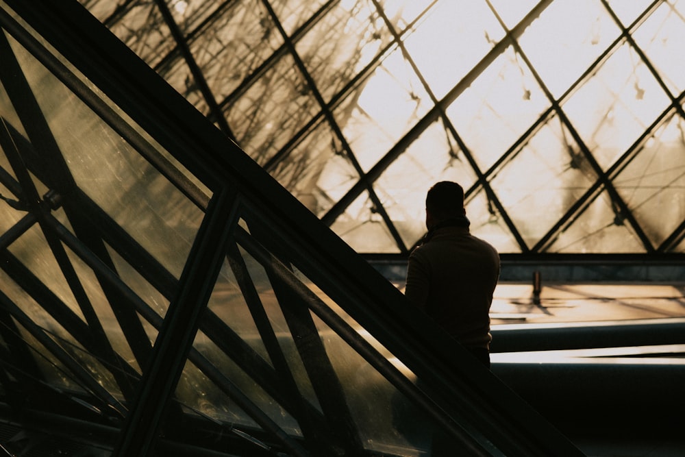 a man standing on an escalator in a building