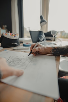 a person is drawing on a piece of paper