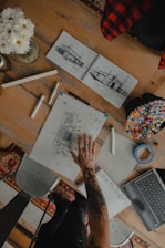 a person sitting at a table with a laptop
