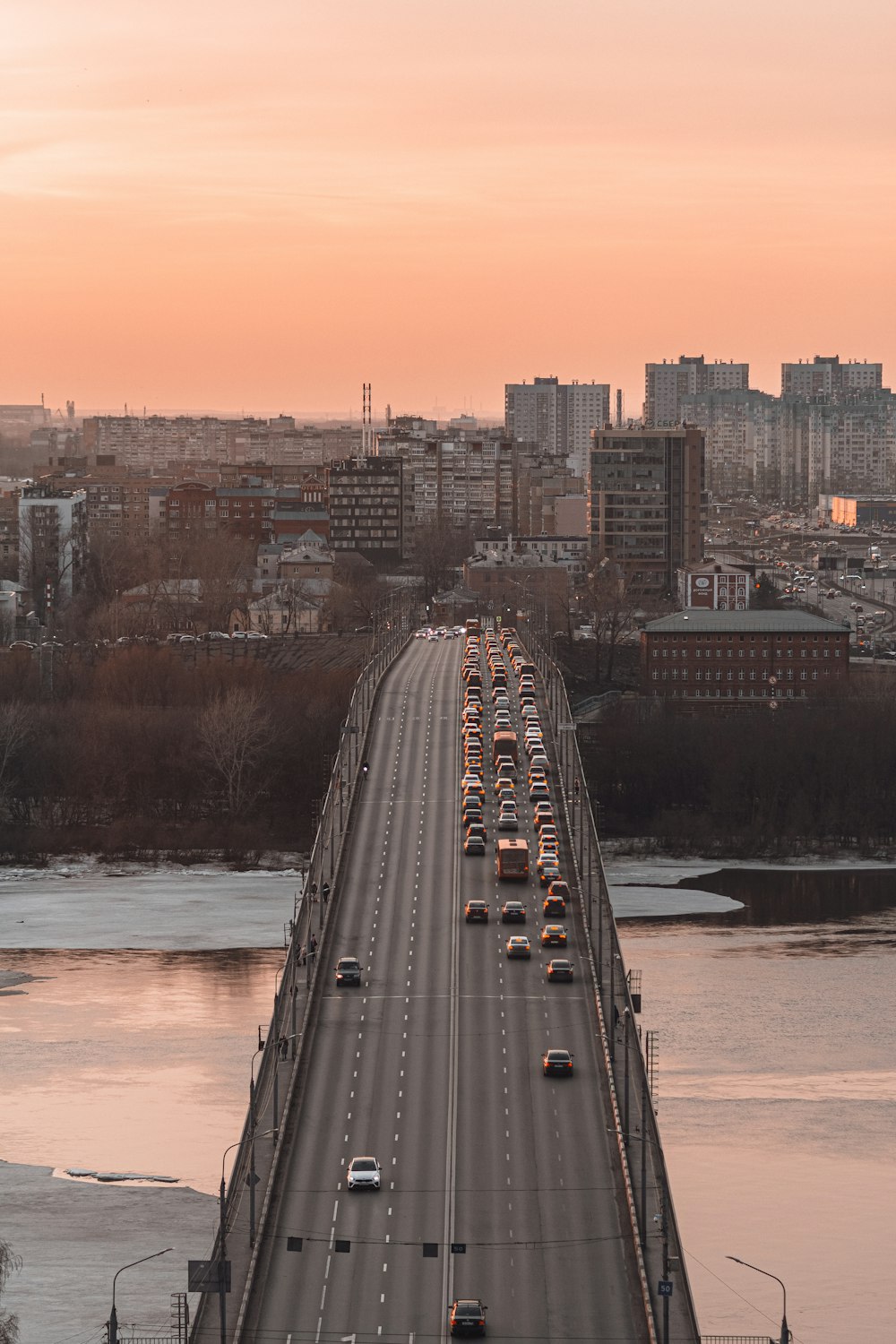 a long bridge over a river with cars on it