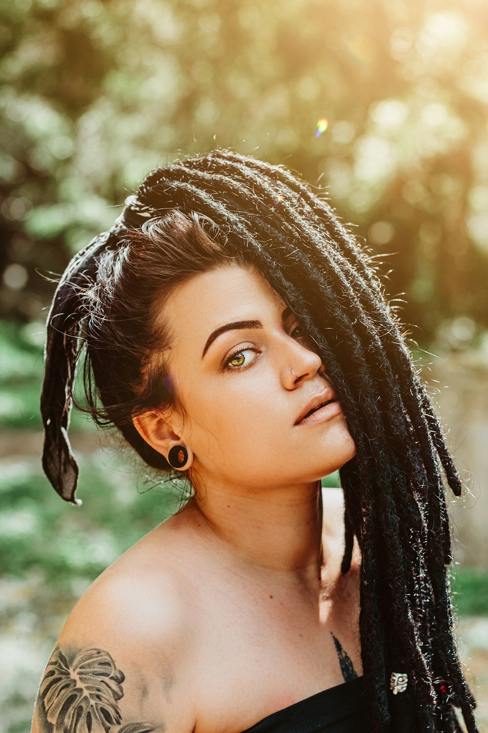 a woman with dreadlocks and a black top