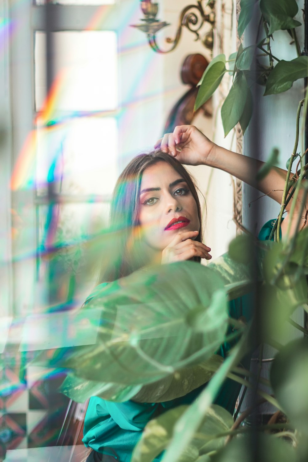 a woman sitting in a chair in front of a window