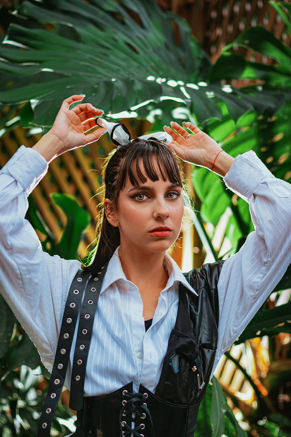 a woman in a white shirt and black vest