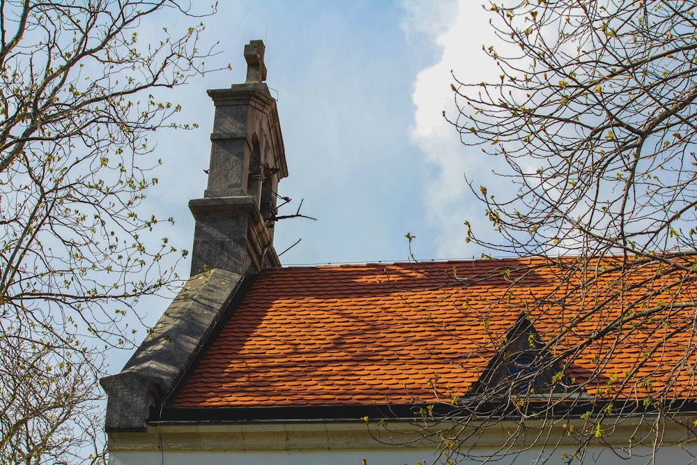 a building with a red tile roof and a steeple