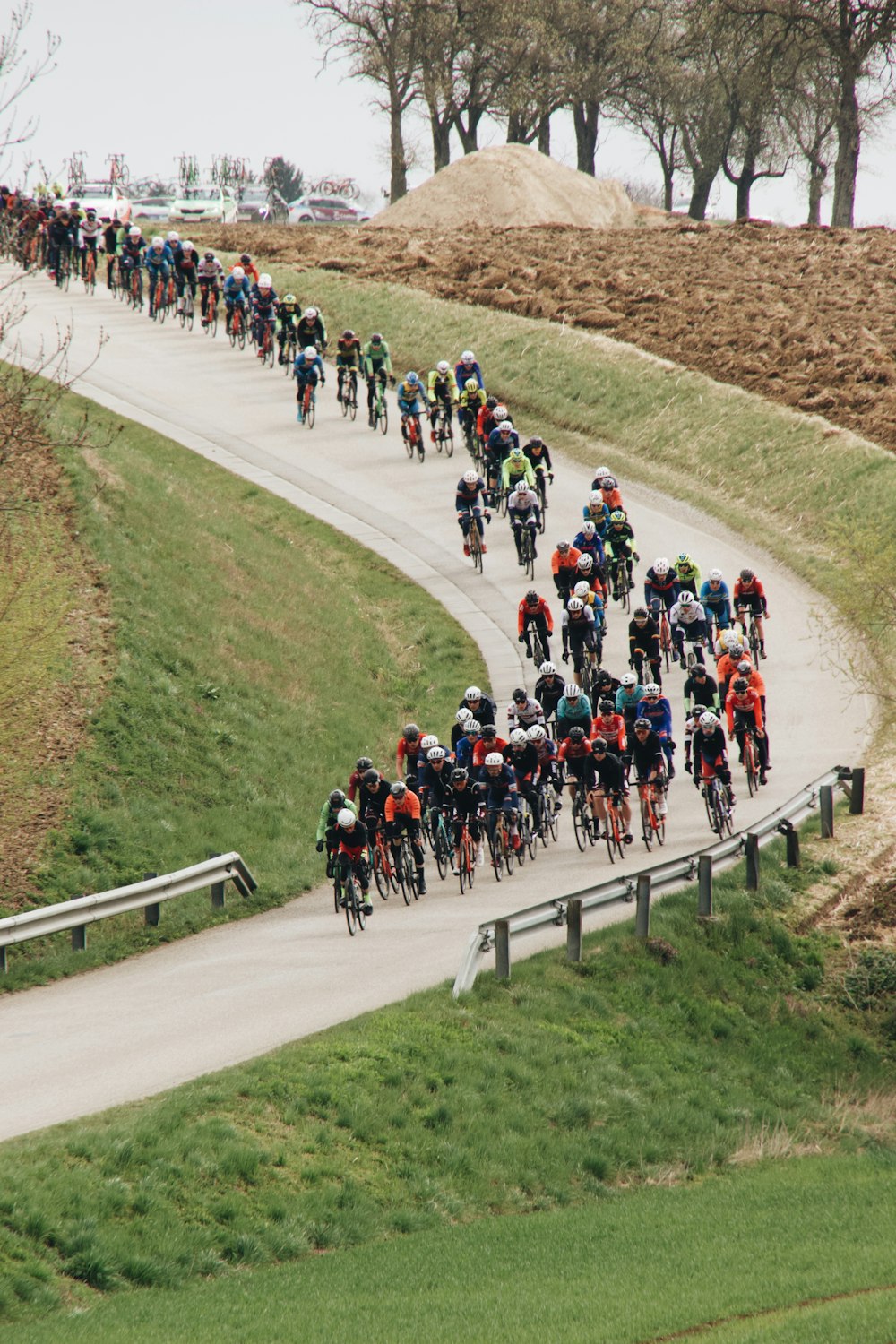 a group of people riding bikes down a road