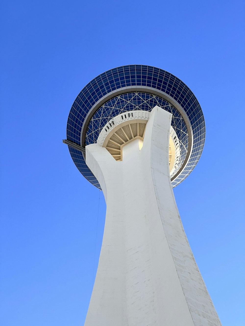 a tall white tower with a blue sky in the background