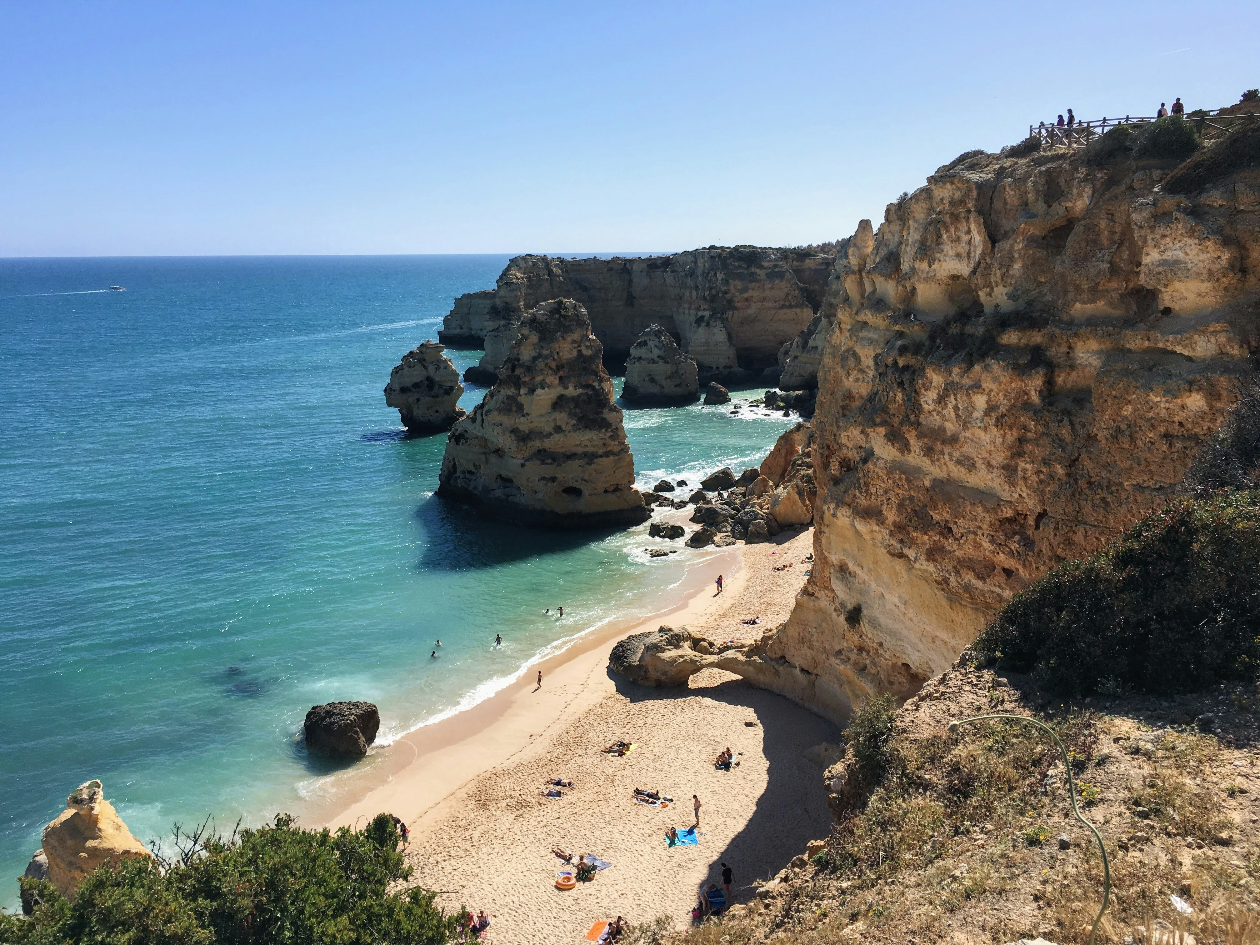 une plage de sable avec des gens dessus à côté de l’océan