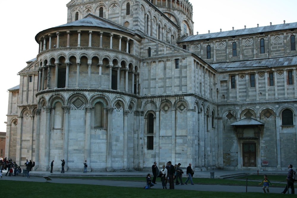 a group of people standing in front of a large building