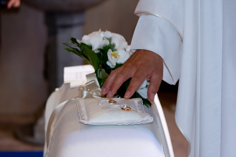 a close up of a person placing flowers on a pillow