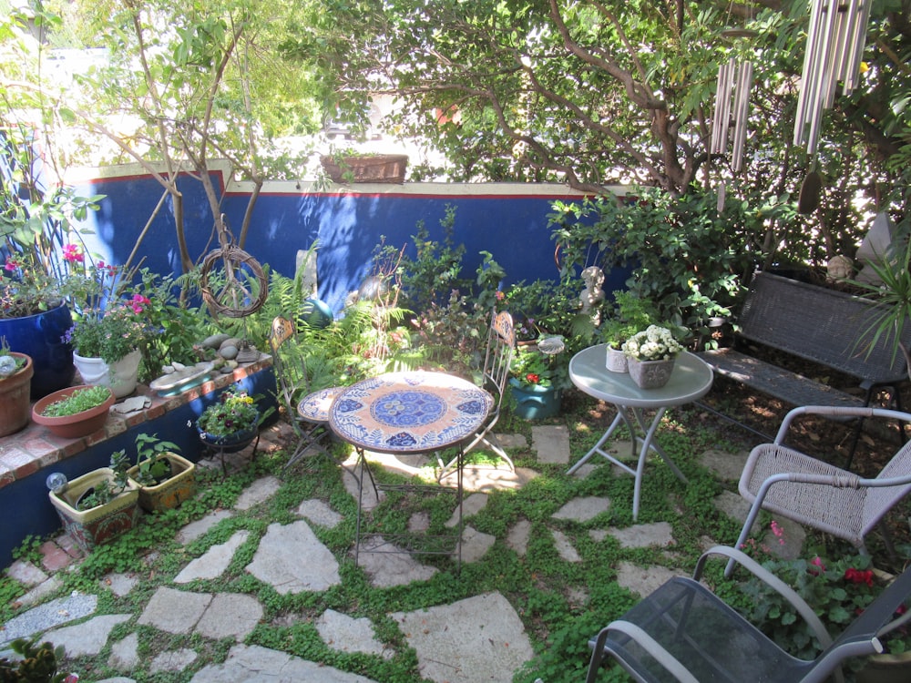 a small garden with a table and chairs