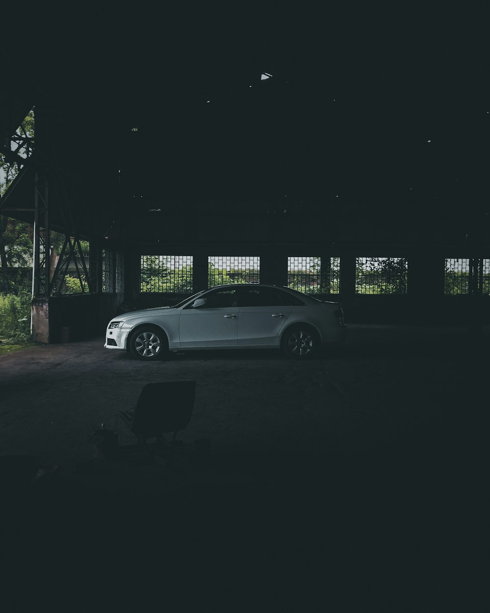 a car is parked in a dark garage