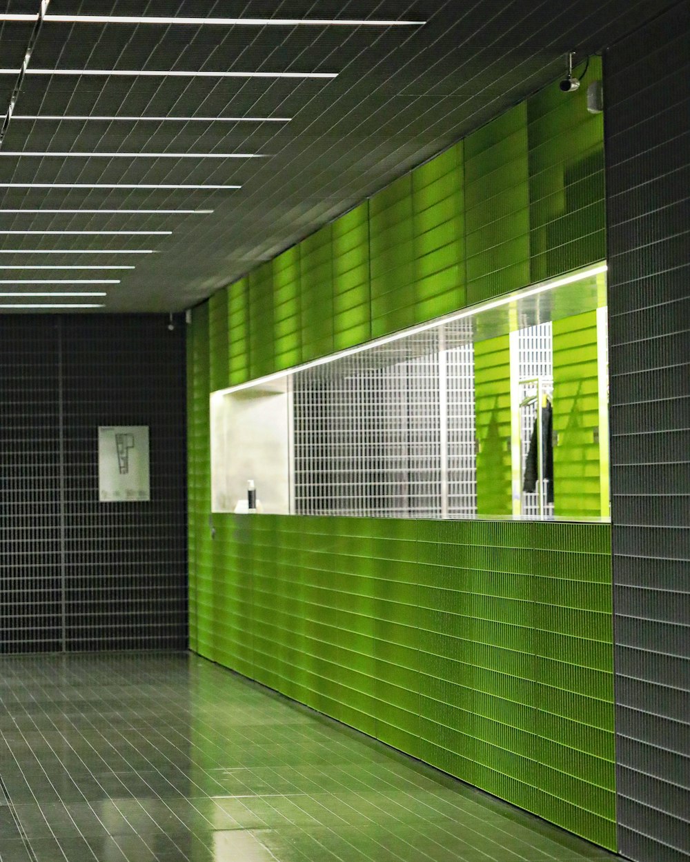 a bathroom with a green wall and tiled floor