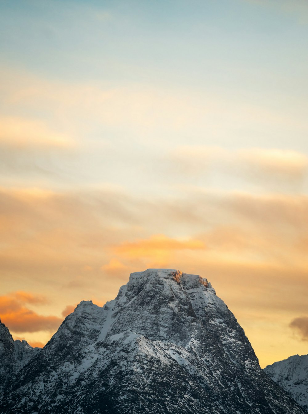 a plane flying over a snow covered mountain