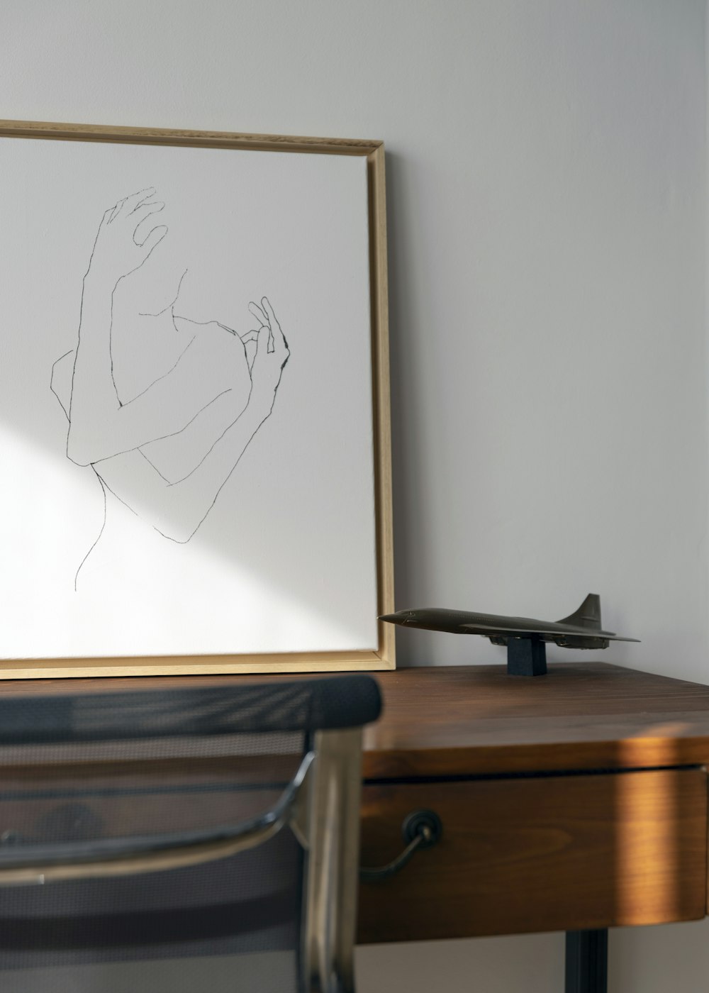 a drawing of a woman is on a desk next to a chair