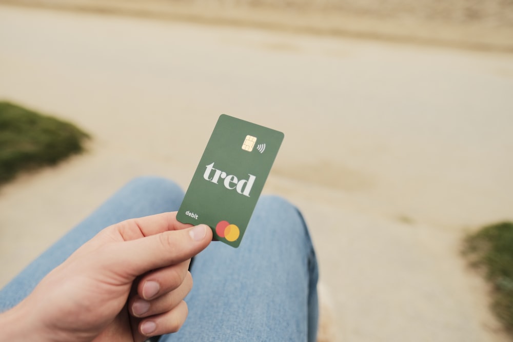 a person holding a credit card in their hand