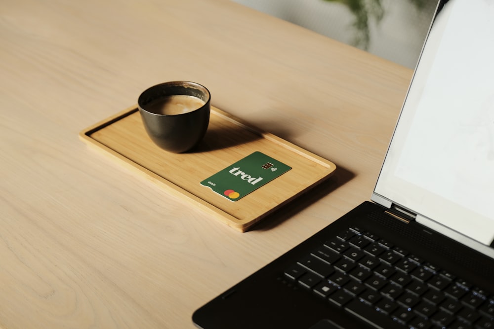 a laptop computer sitting on top of a wooden desk