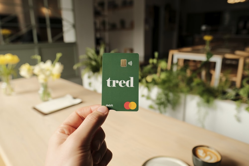 a person holding up a card with the word tired on it