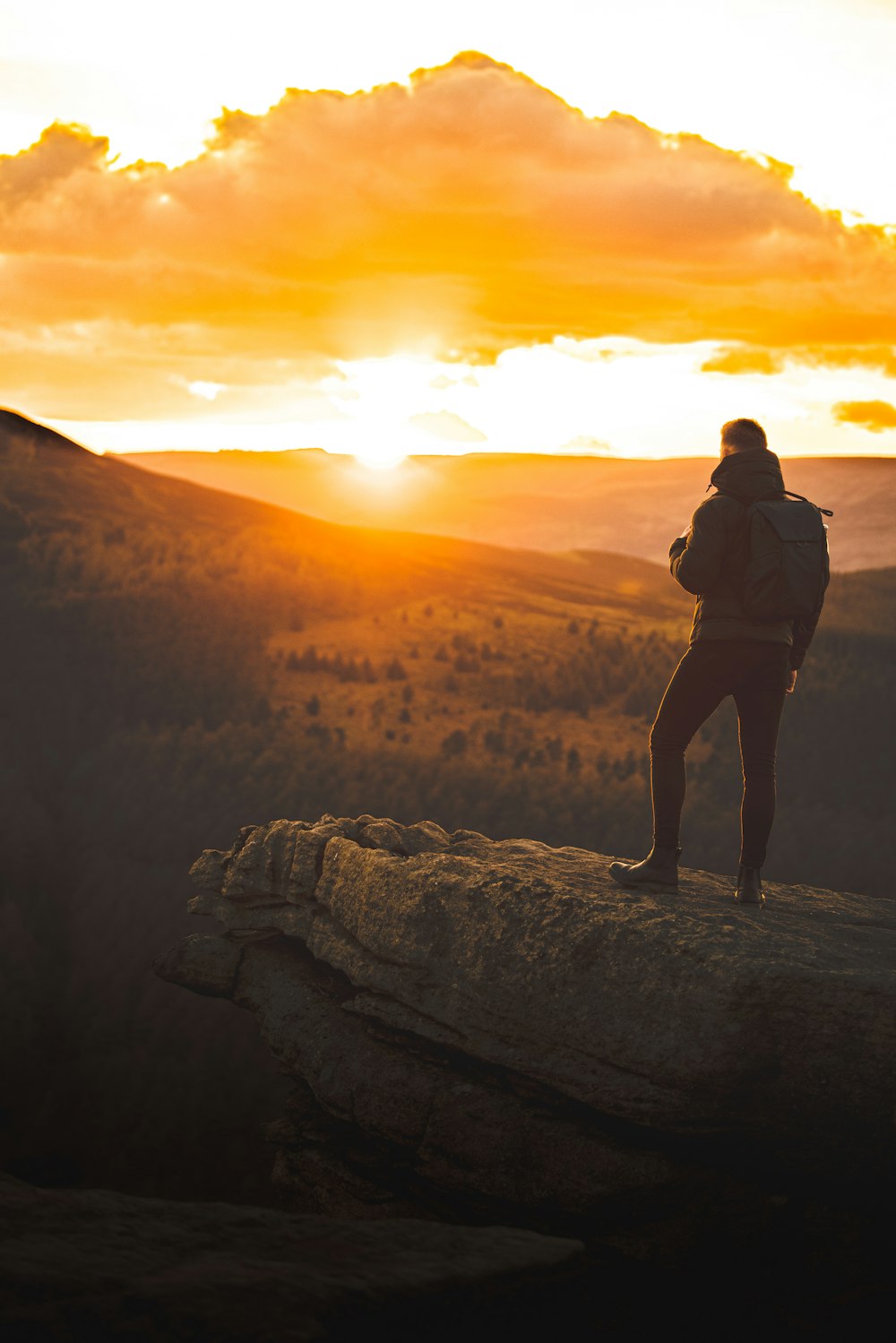 a person standing on top of a large rock