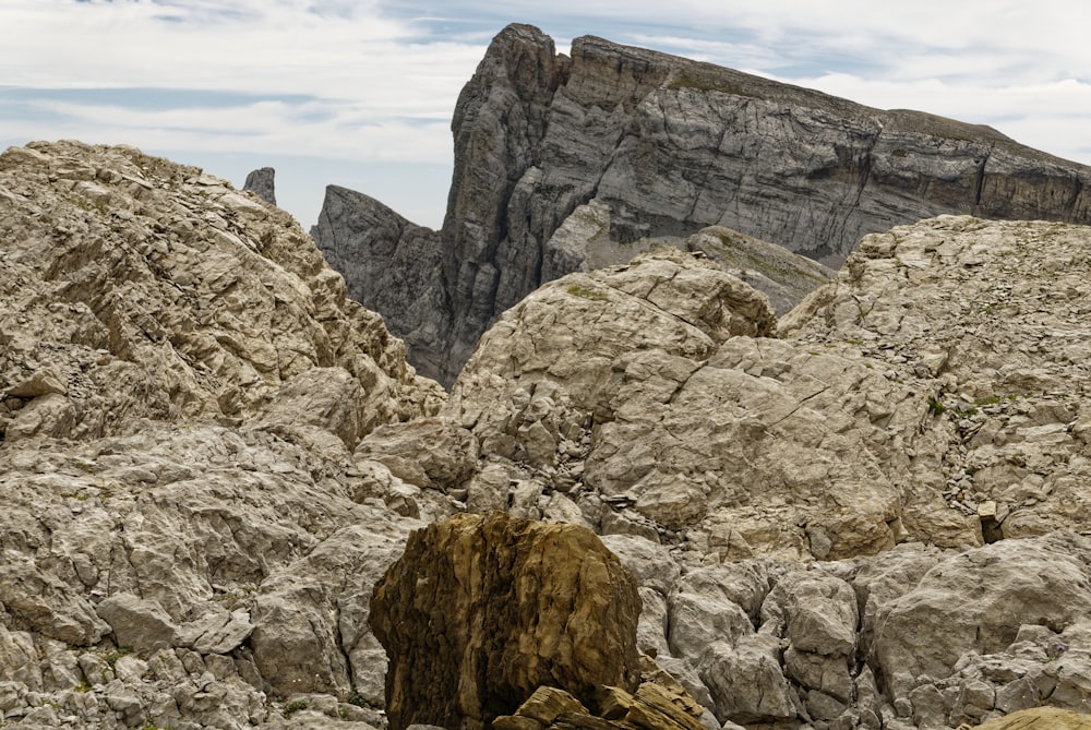 a large rock formation with a mountain in the background