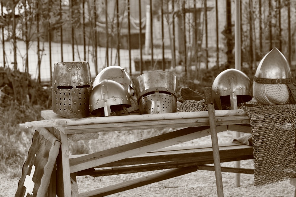 a wooden table topped with lots of metal shoes