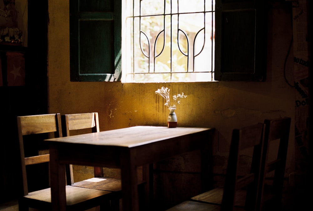 a wooden table with a vase of flowers on top of it