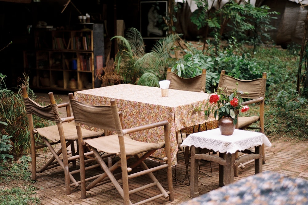 a table with chairs and a table cloth on it