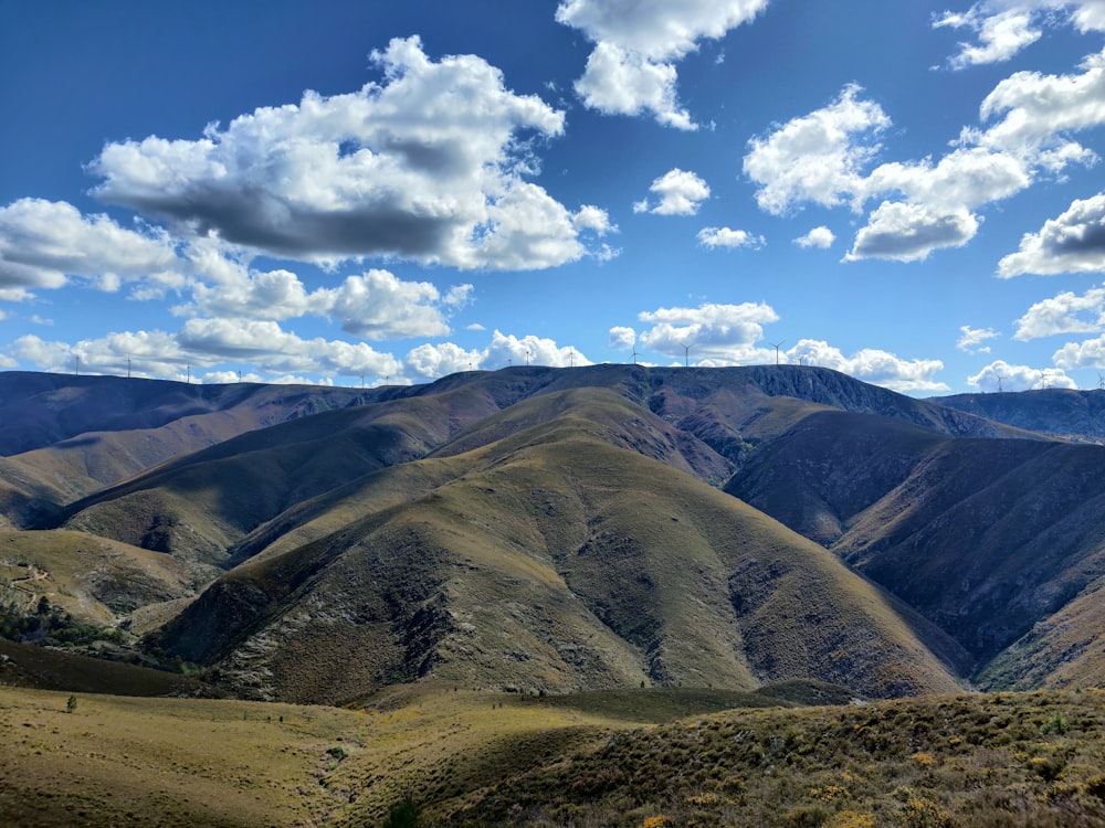 a scenic view of a mountain range with clouds in the sky