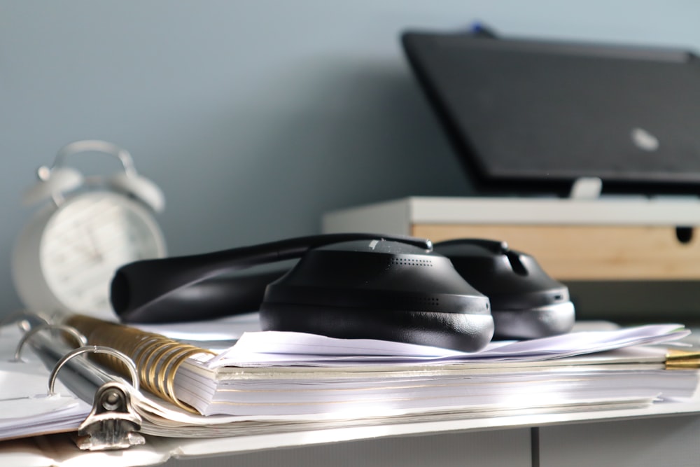 a desk with a laptop and a phone on it