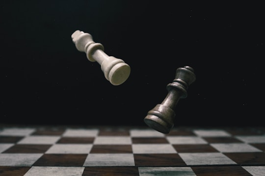 a black and white checkered chess board with a white pawn