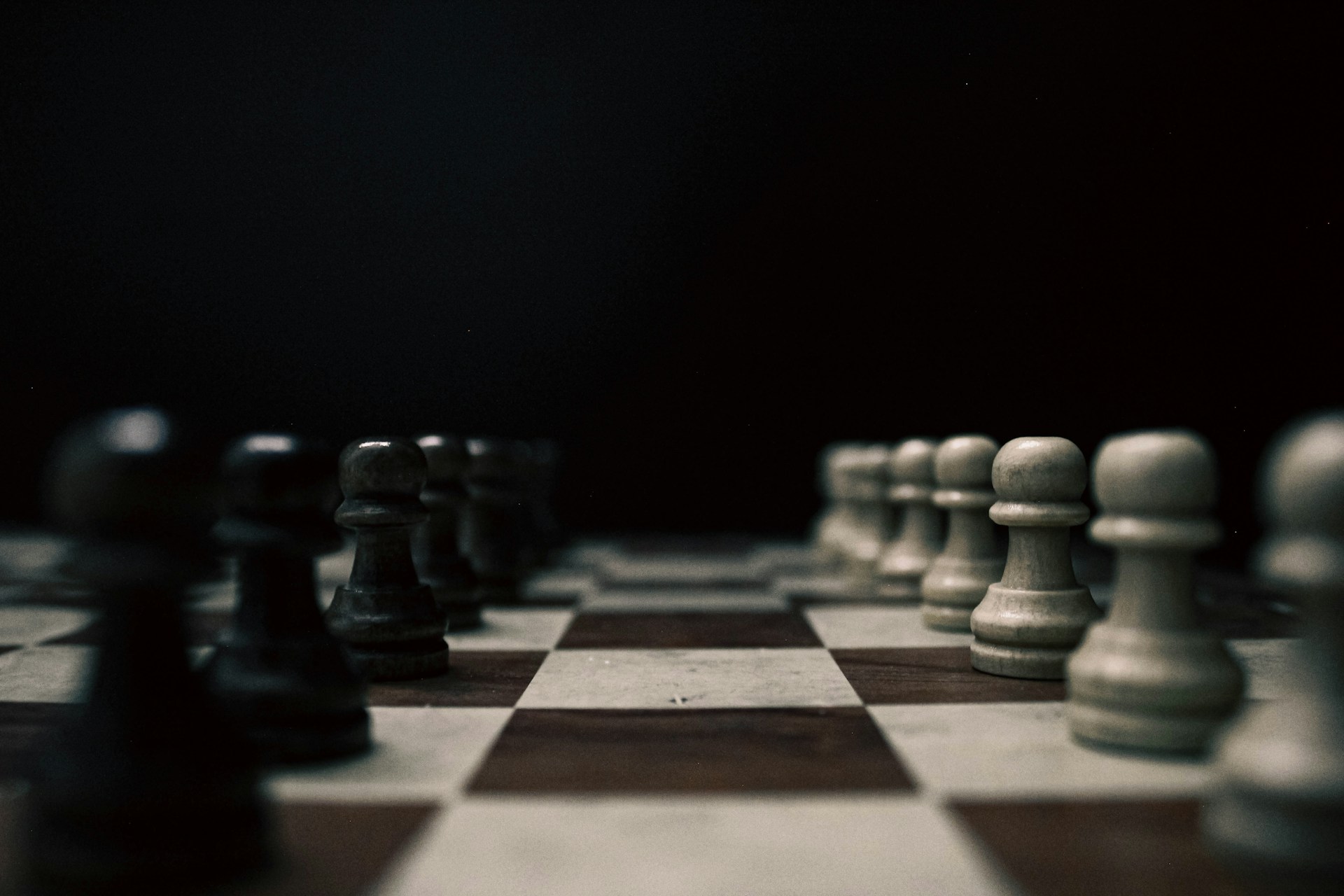 a black and white chess board with pieces on it