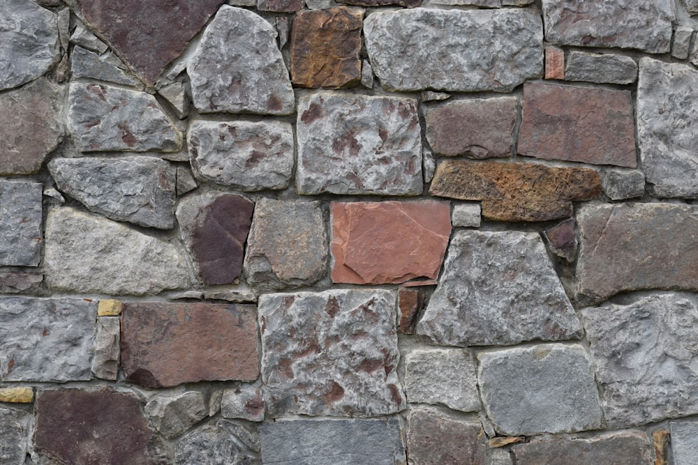 a close up of a stone wall made of rocks