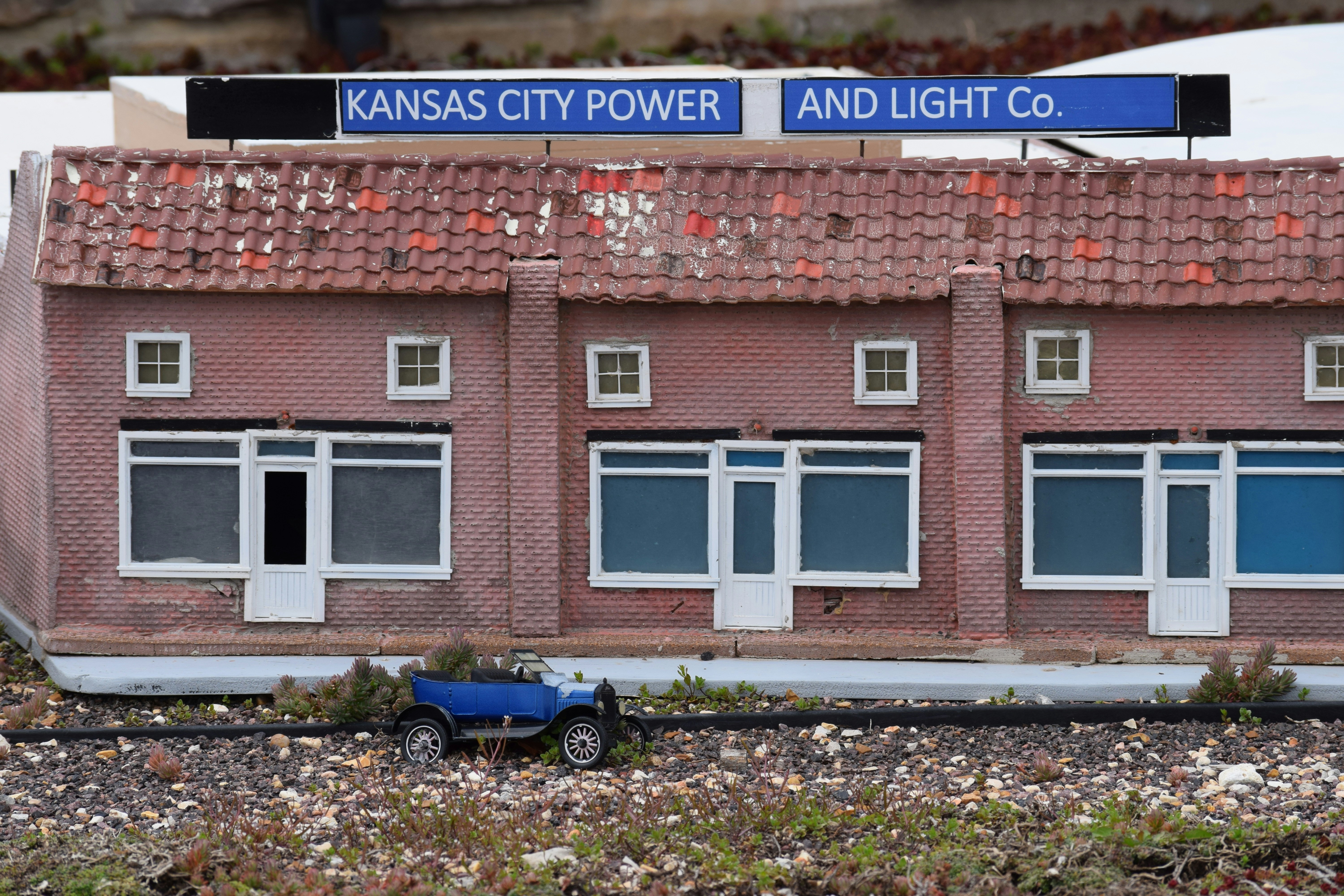a toy car is parked in front of a building