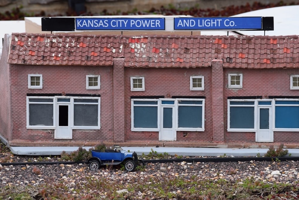 a toy car is parked in front of a building