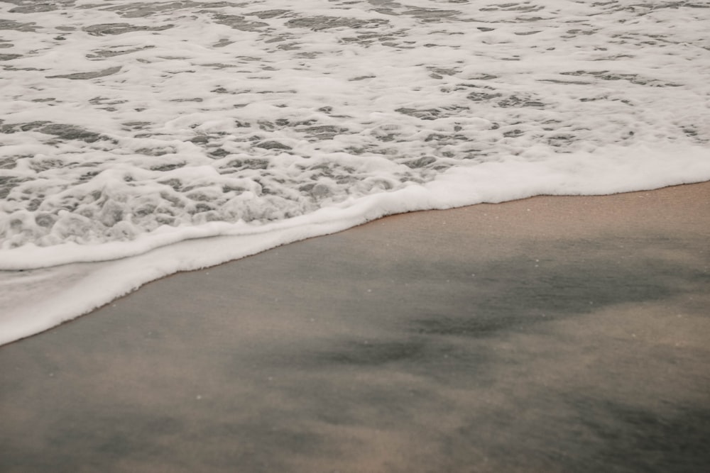 a close up of a wave on a beach