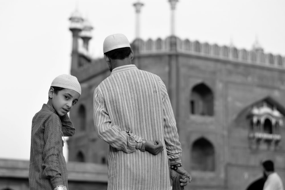 a black and white photo of a man and a boy